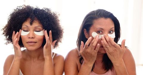 mother and daughter applying under-eye patches for skincare routine - Download Free Stock Images Pikwizard.com