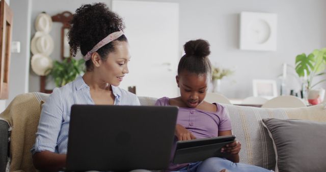 Mother and Daughter Using Laptop and Tablet on Couch - Download Free Stock Images Pikwizard.com