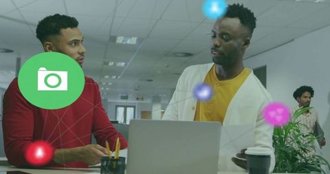 Diverse Professionals Discussing Data in Open Plan Office Environment