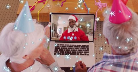 Seniors Video Calling Family on Christmas, Celebrating with Festive Hats