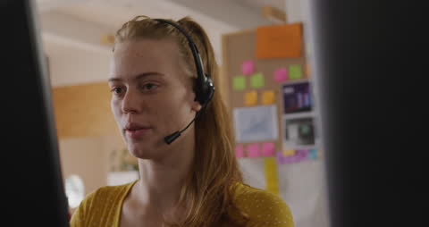 Professional Woman Engaged in Office Headset Call in Modern Workspace