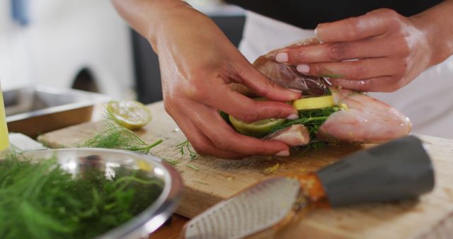 Chef Preparing Fresh Fish Stuffed with Herbs and Lemon in Kitchen - Download Free Stock Images Pikwizard.com