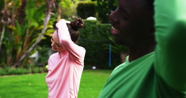 Friends Smiling and Stretching in Outdoor Park Setting - Download Free Stock Images Pikwizard.com