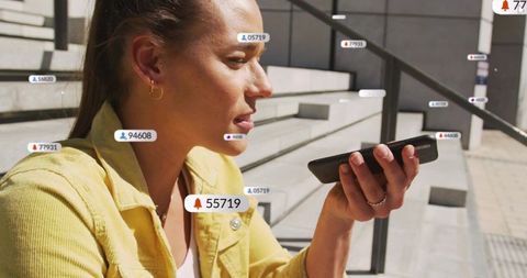 Woman speaking into smartphone with floating notification overlays on urban concrete steps