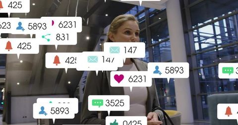 Businesswoman in modern atrium surrounded by social media notification overlays