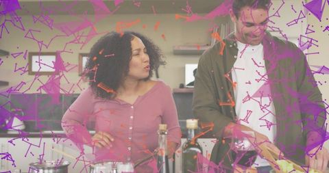 Couple cooking together in modern kitchen with purple abstract overlay, woman talking, man chopping