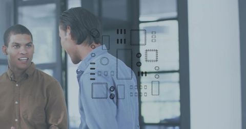 Coworkers discussing tech design with circuit overlay in modern office workspace