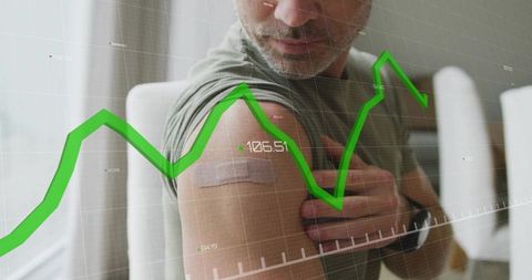 Mature man checking vaccination bandage while AR health graph displaying data