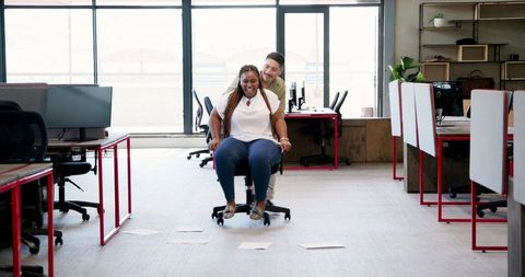 Joyful colleagues engaging in office fun and team building