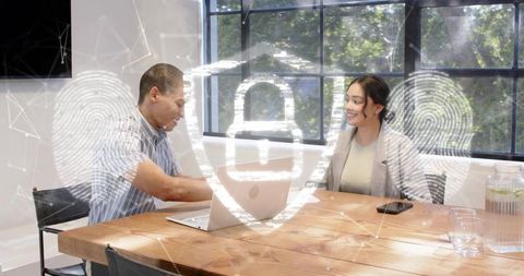 Colleagues discussing cybersecurity strategy at office table with fingerprint lock overlay