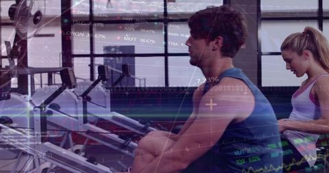 Muscular man rowing on ergometer with female partner, digital analytics overlay for cardio training