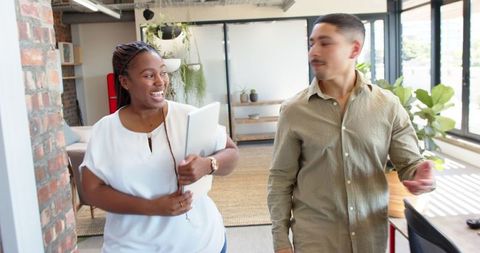 Diverse Colleagues Collaborating in Modern Office, Smiling