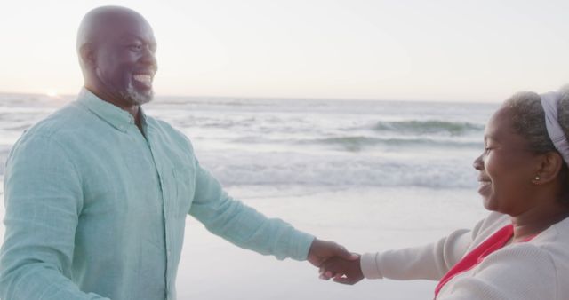 Happy senior african american couple holding hands on sunny beach at sunset, copy space - Download Free Stock Photos Pikwizard.com