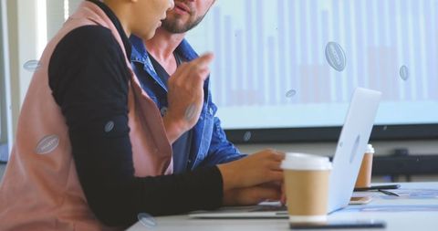 Colleagues Collaborating with Laptop in Office
