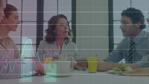 Business Team Analyzing Growth Charts During Lunch Meeting