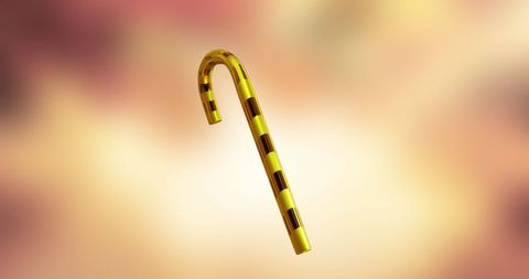 Golden Candy Cane on Glowing Yellow Background at Festive Season