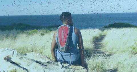 Adventurous hiker resting in scenic coastal landscape