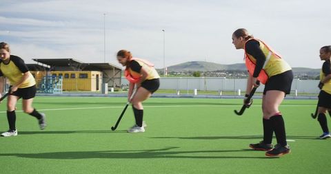 Female Field Hockey Team Preparing for Competition Outdoors