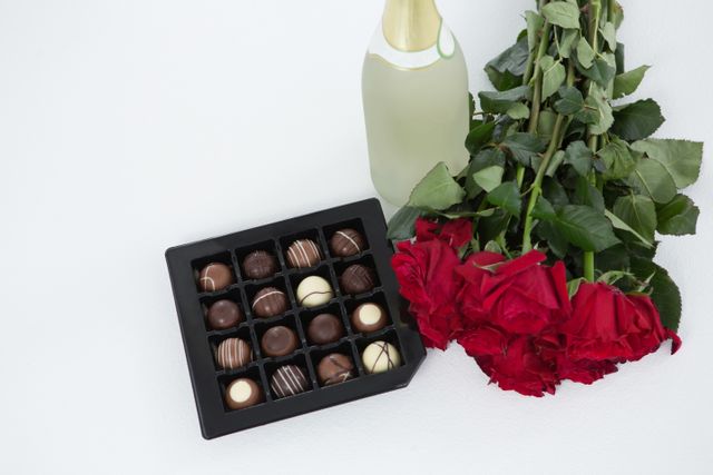 Gift, chocolate box, roses and champagne bottle on white background - Download Free Stock Photos Pikwizard.com