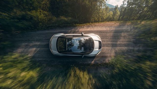 Luxury sedan exploring scenic forest road adventure