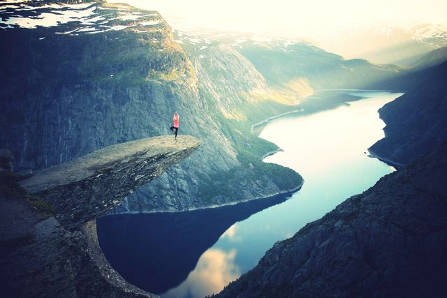 Woman Doing Yoga on Cliff Overlooking Scenic Fjord - Download Free Stock Photos Pikwizard.com
