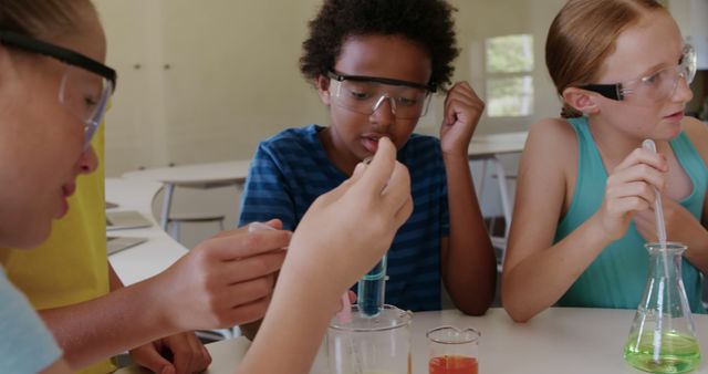 Diverse group of children conducting chemistry experiment in classroom - Download Free Stock Images Pikwizard.com