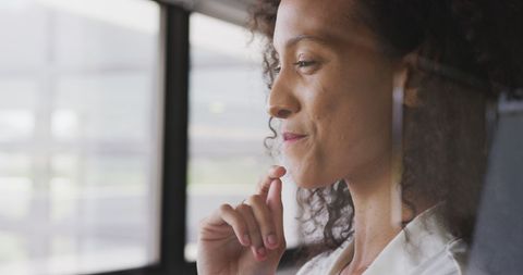 Thoughtful Businesswoman Looking Out Office Window