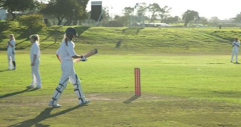 Female Cricket Players Competing in Sunny Field - Download Free Stock Images Pikwizard.com