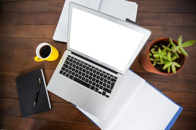 Overhead View Transparent Laptop with Coffee and Potted Plant - Download Free Stock Videos Pikwizard.com