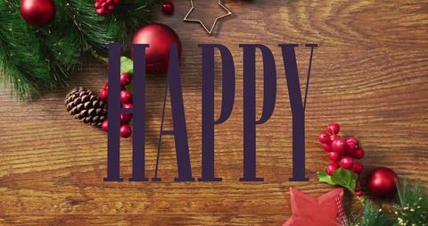 Rustic christmas tabletop featuring large happy letters with evergreen, red baubles