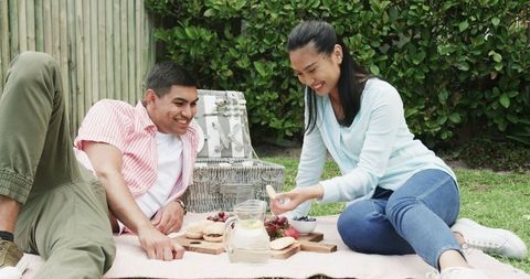 Romantic Picnic with Relaxed Young Couple Outdoors during Sunniness