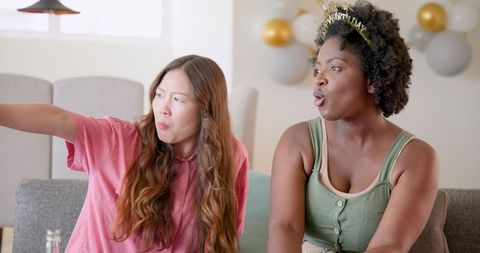 Diverse Friends Celebrating Birthday Together on Couch