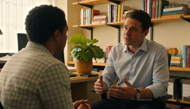 Business mentor discussing career guidance with young professional in bright office