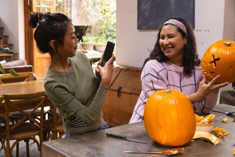 Mother and Daughter Enjoying Pumpkin Carving for Halloween Fun