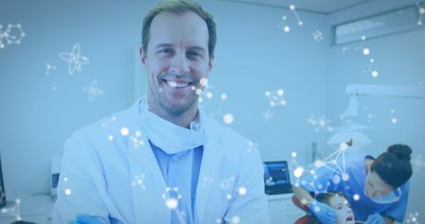 Professional dentist wearing a white coat smiling warmly in a bright modern dental office with a young patient being assisted by a nurse. Ideal for healthcare or dental care promotions, illustrating friendly and professional healthcare environments.