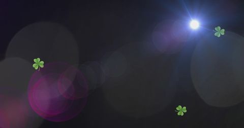 Abstract Light Spots with Clovers on Dark Background