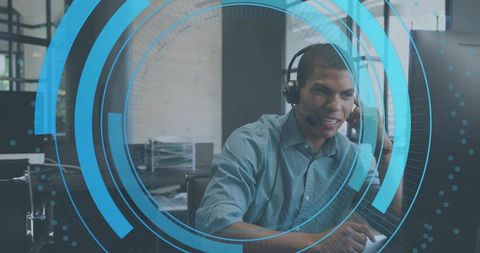 Customer support agent wearing headset typing at workstation with futuristic hud overlay