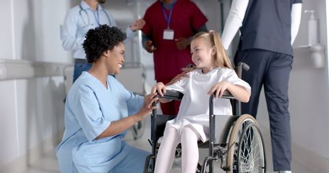 Nurse Assisting Child in Wheelchair at Hospital - Download Free Stock Images Pikwizard.com