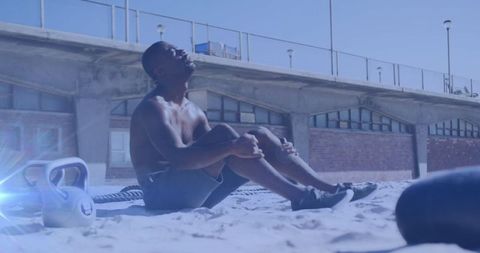 Man Resting During Beach Workout with Scenic Backdrop