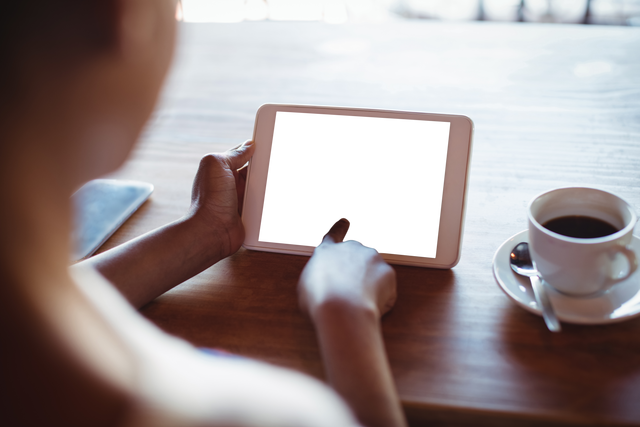 Transparent Screen Digital Tablet in Cafe Setting with Coffee - Download Free Stock Videos Pikwizard.com