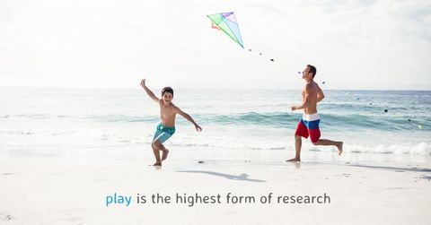 Father and son enjoy kite flying on scenic beach
