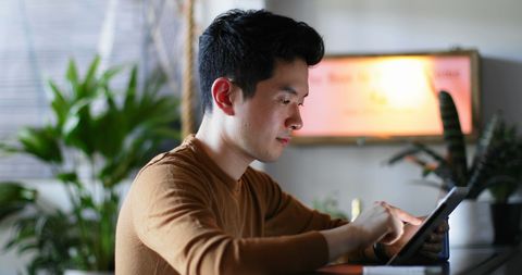 Young Professional Using Tablet in Home Office