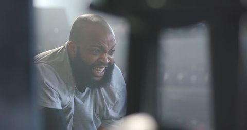 Bearded control room operator shouting at monitors during intense technical troubleshooting