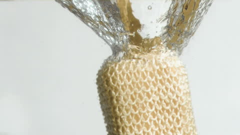Loofah Glove Immersed in Water in Super Slow Motion