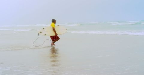 Senior African American Surfer Running with Surfboard Towards Ocean Waves - Download Free Stock Images Pikwizard.com