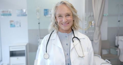 Confident senior female doctor in hospital room