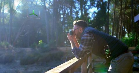 Photographer in Nature Capturing Scenic Landscape with DSLR