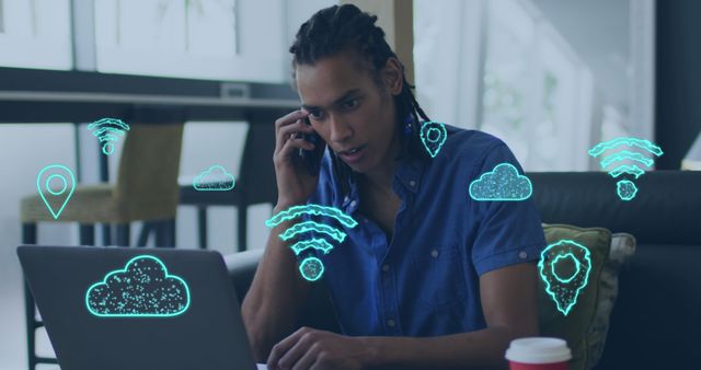 Composite of cloud and wifi icons over briacial businessman using smartphone and laptop in office. Global business, finance, data processing and digital interface concept digitally generated image.