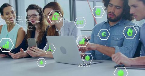 Multidisciplinary team collaborating around laptop with augmented analytics overlays and innovation