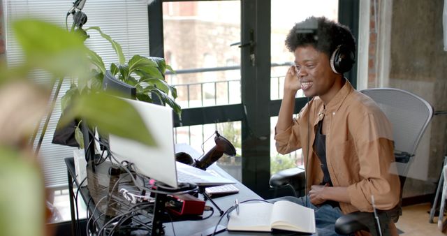 Young Professional Using Computer and Headset in Modern Office - Download Free Stock Images Pikwizard.com